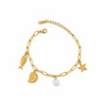 Bracelet La boutique d'Emma doré à maillons avec charms poisson, coquillage, étoile de mer et perle nacrée