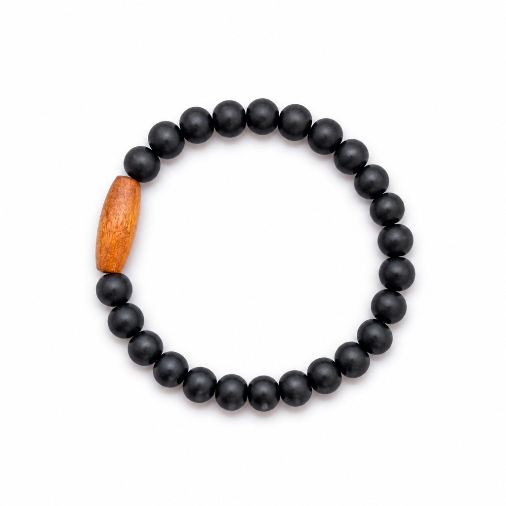 Bracelet élastique La boutique d'Emma en perles noires mates avec une perle centrale en bois sculpté