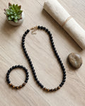 Parure La boutique d'Emma composée d'un collier et d'un bracelet en perles noires mates et pierres œil de tigre